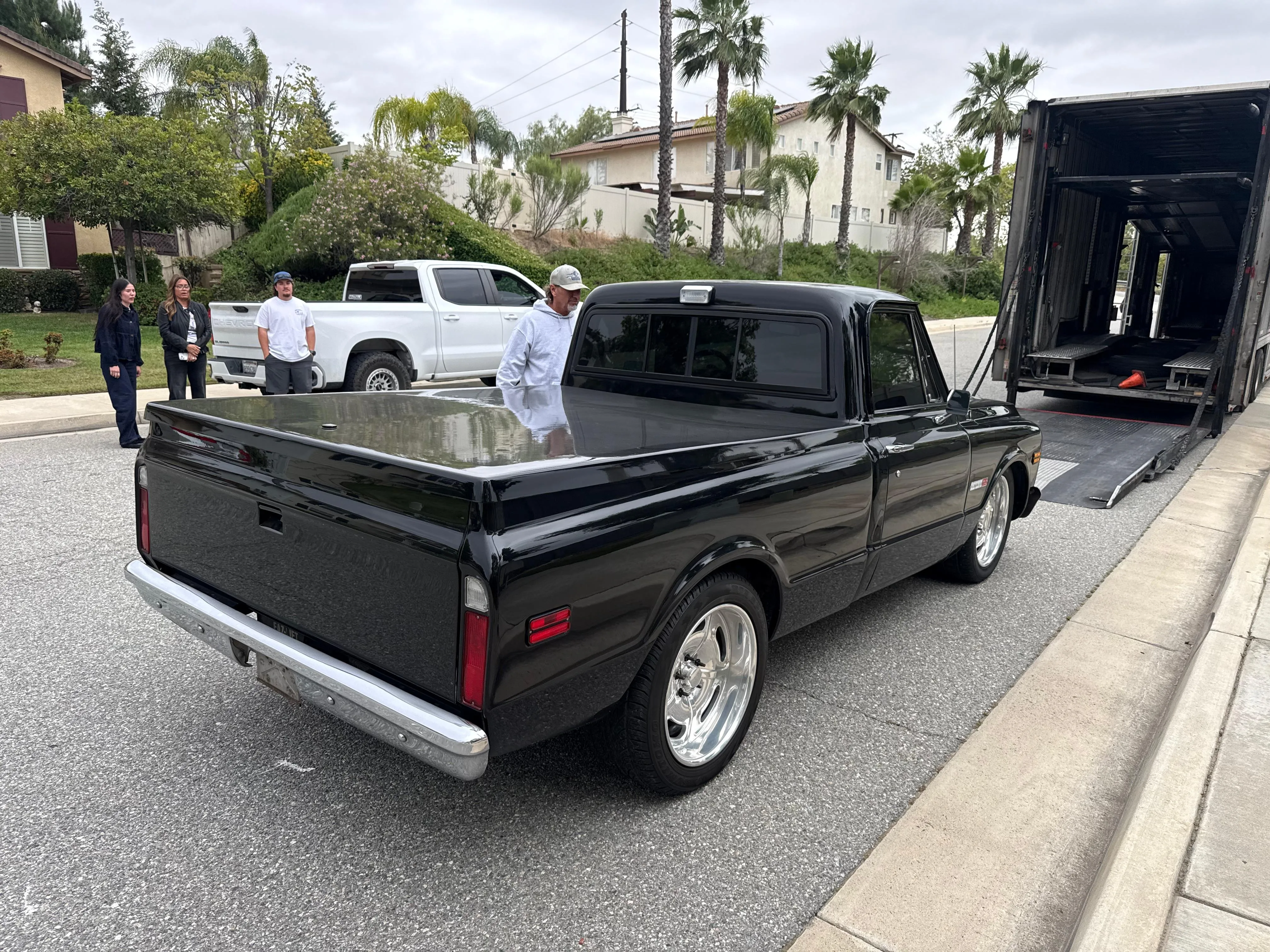 Classic black pickup truck delivered on car hauler