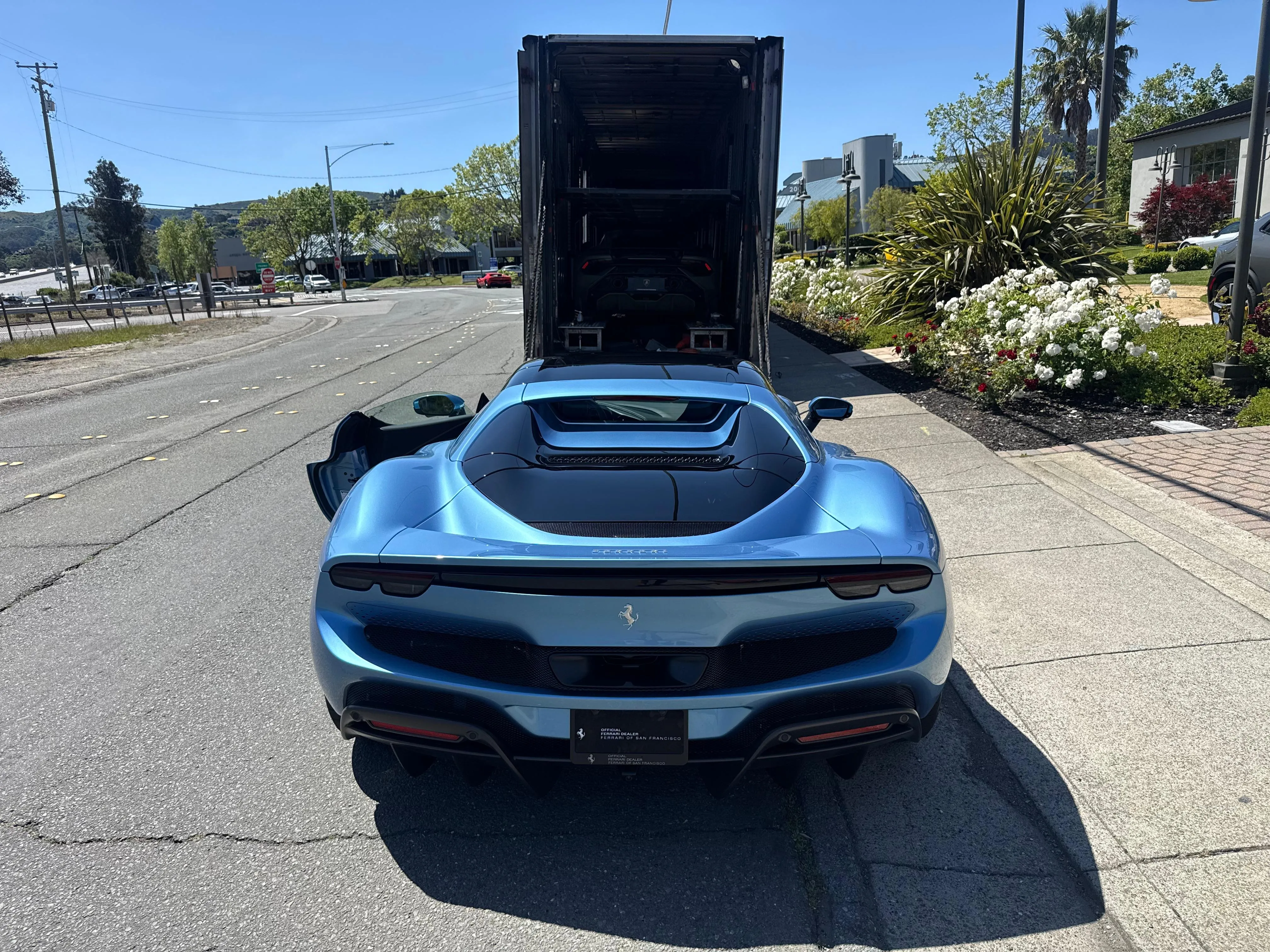 Blue Ferrari delivered from enclosed car carrier