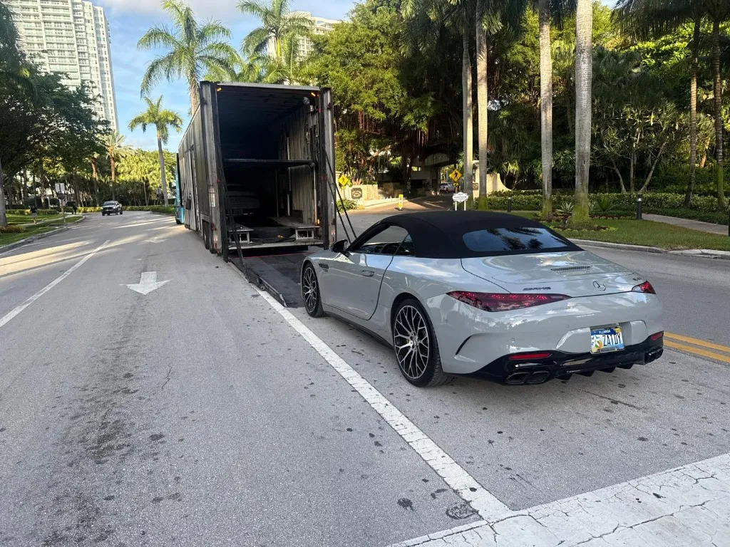 Gray Mercedes SL Convertible unloaded from enclosed trailer